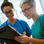 nurses-smiling-over-clipboard