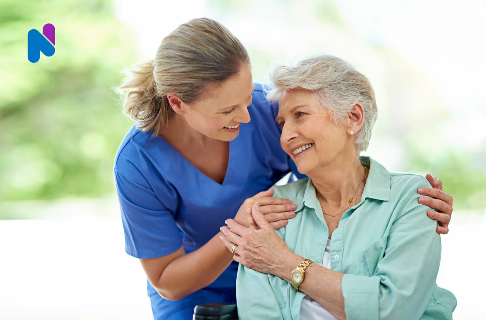 nurse-holding-senior-woman-and-smiling