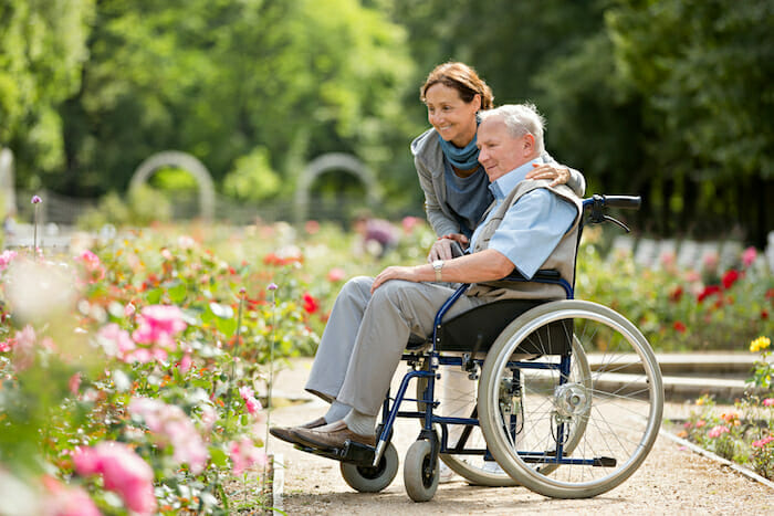 Assisted living – caregiver and senior man on a wheelchair