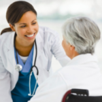 a nurse helping a senior lady in a wheelchair