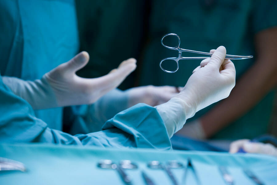 nurses in surgery center operating on a patient