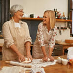 senior mom and daughter doing heart healthy holiday cooking for loved ones with congestive heart failure