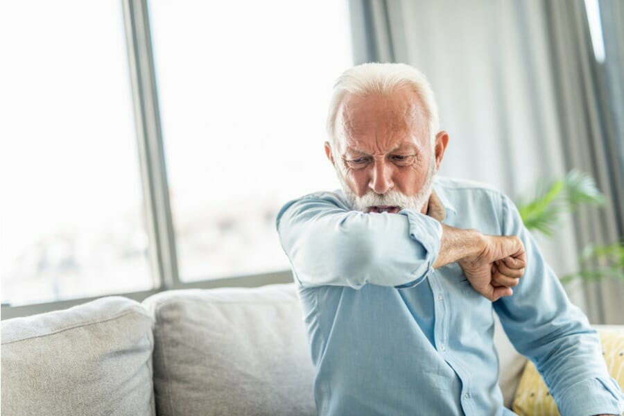 an old man with pneumonia coughing