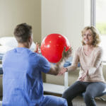 Physical therapist helping patient