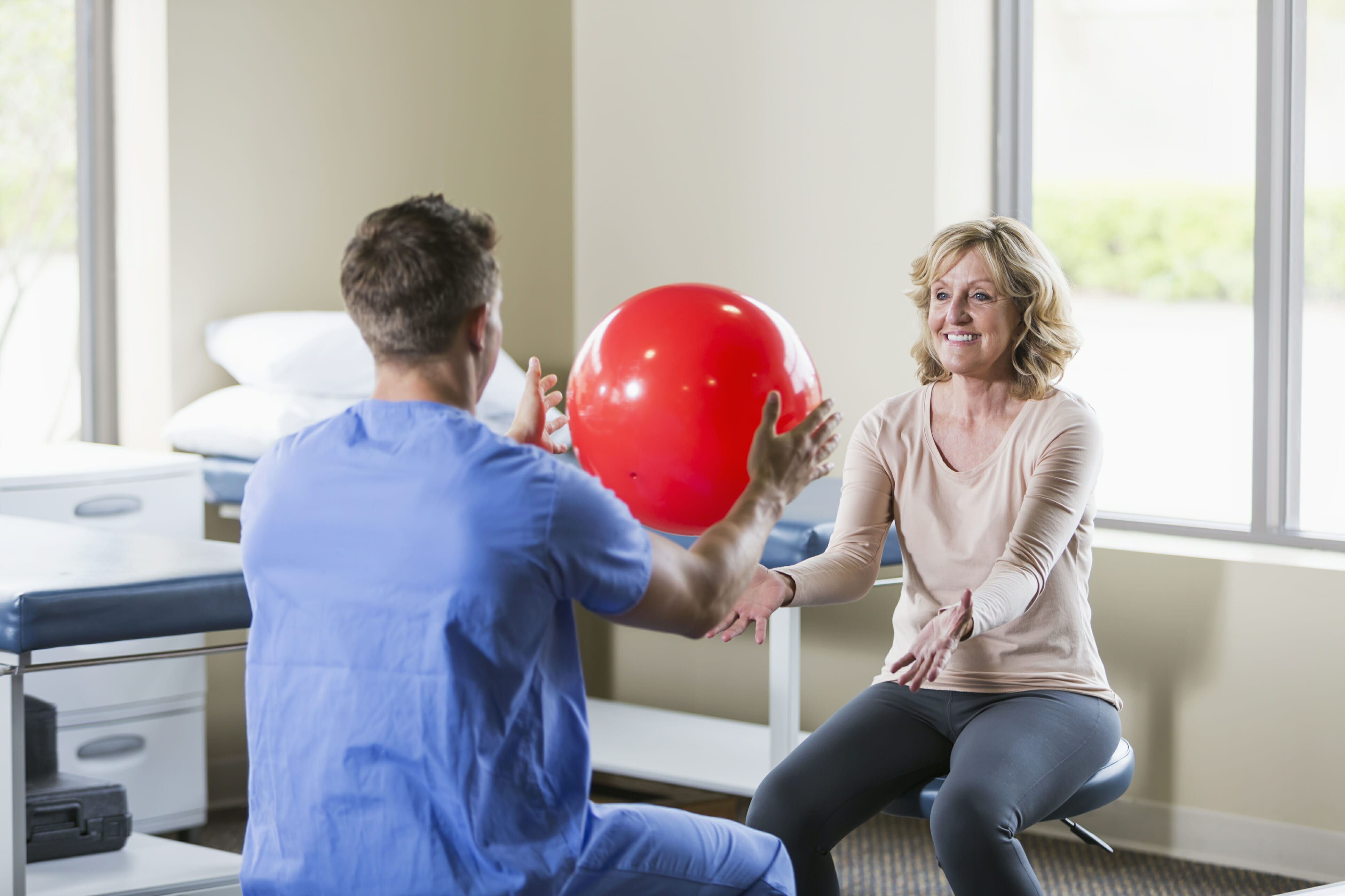 Physical therapist helping patient