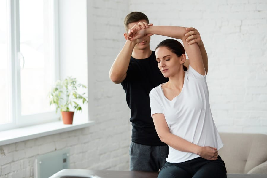 patient stretching during physical therapy