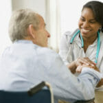 nurse checking up on senior man with shingles