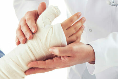 doctor wrapping the hand of a child