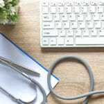 stethoscope, clipboard and computer keyboard