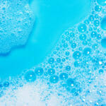 white bubble foam on bright blue background