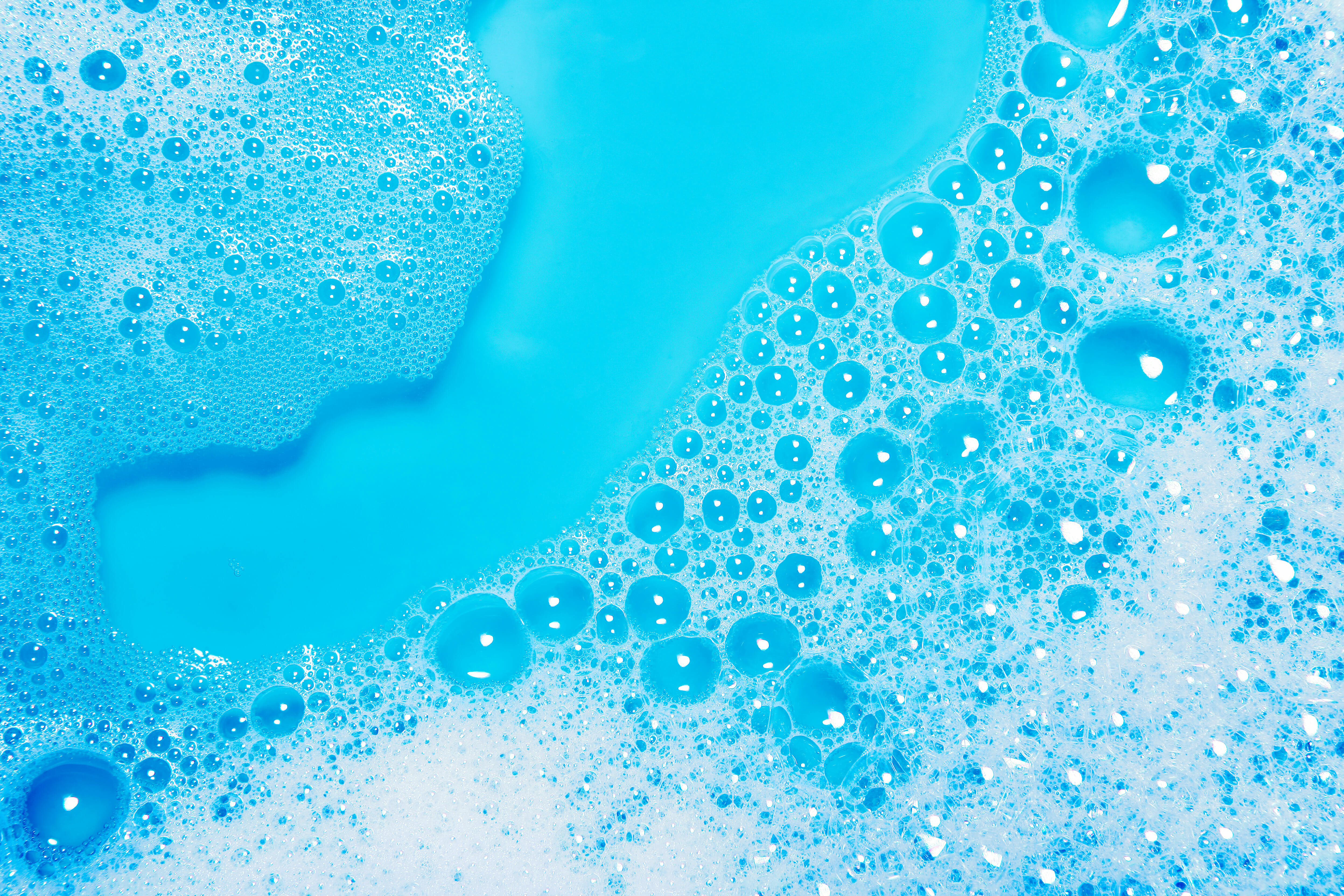 white bubble foam on bright blue background