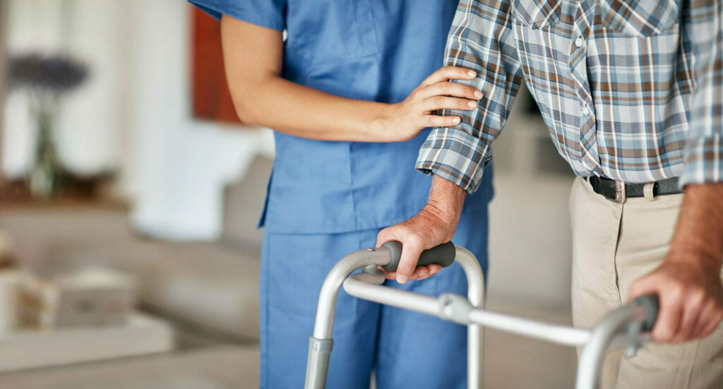 post hospital care nurse helping older man with walker