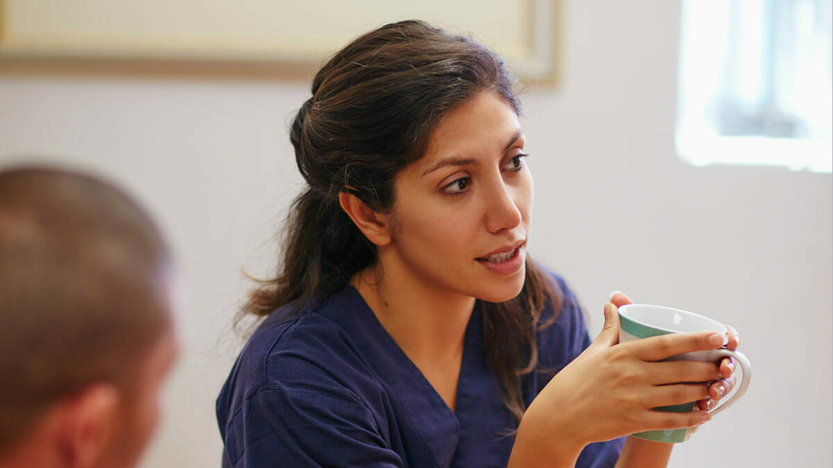 nurse holding coffee mug