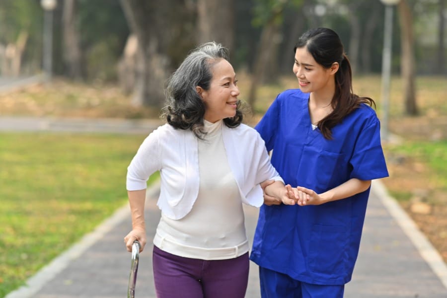 in home nurse walking with her client