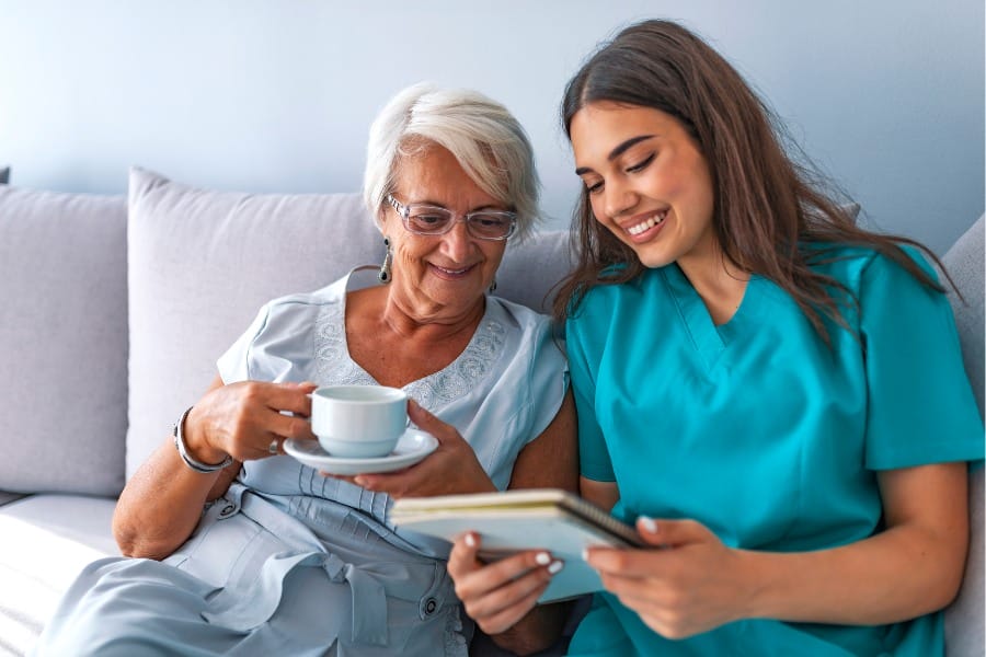 Private duty nurse reading with a patient