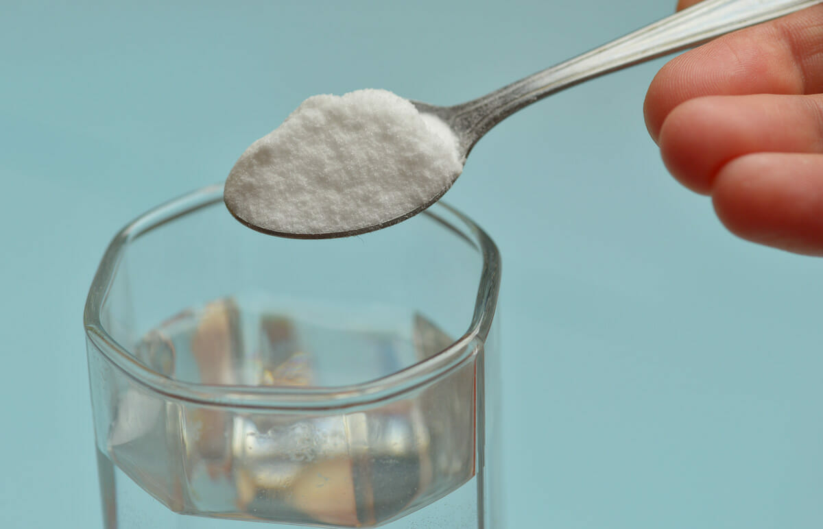 mixing sodium bicarbonate in water to drink