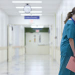 Doctor Resting Head on Wall