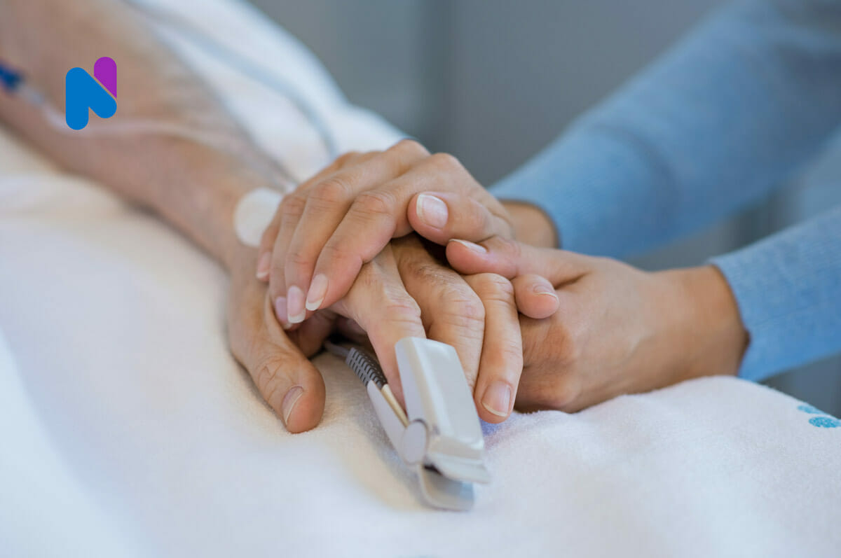 Patient holding hands with medical professional