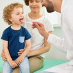 Pediatrician examines child for PANDAS symptoms
