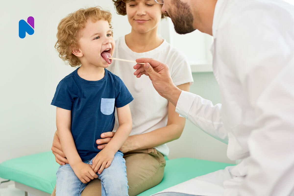 Pediatrician examines child for PANDAS symptoms