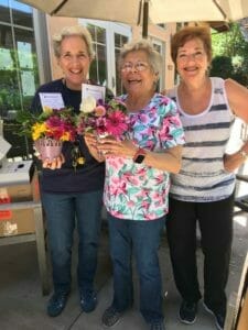 volunteers of random acts of flowers handing out flower donations at avenidas