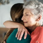 older-woman-hugging-daughter-in-pain