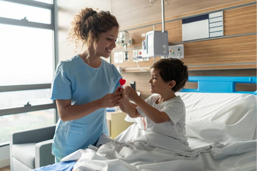 A young child and her nurse in a healthcare facility