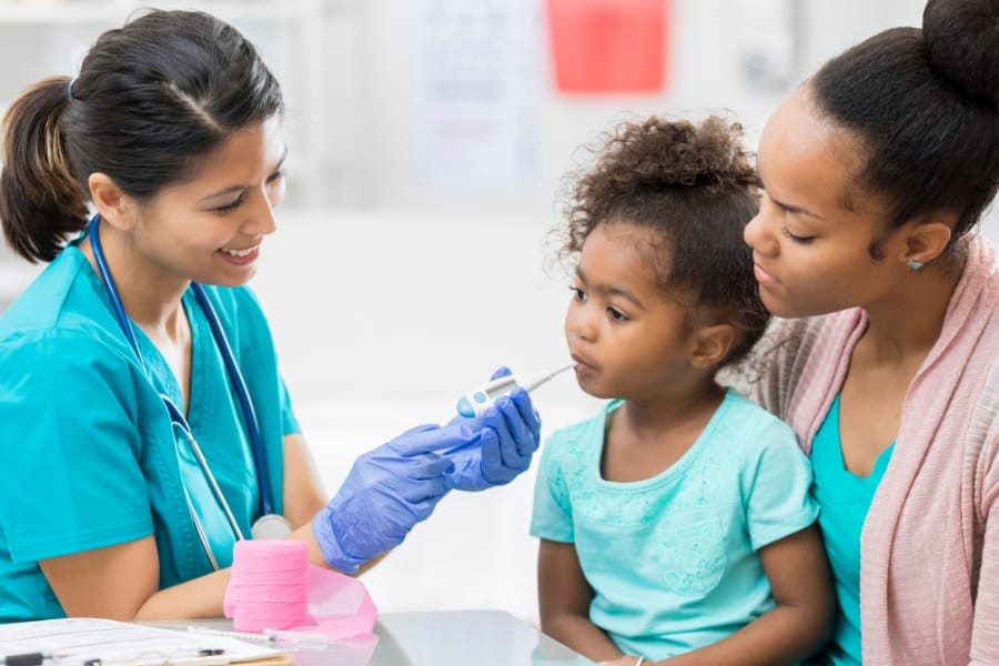 A young patient and her mother seeing a pediatric nurse