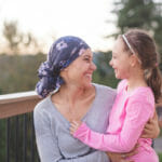 mom and daughter smiling