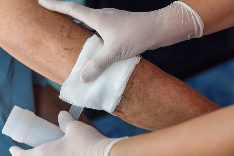 A man with hemophilia being treated for a cut