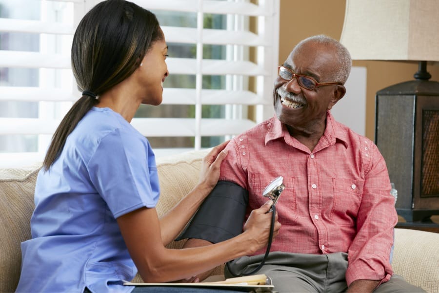 home nurse checking a patient's bloodpressure