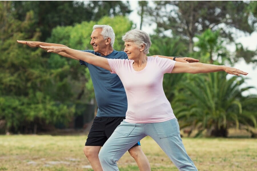 elderly individual with arthritis doing yoga