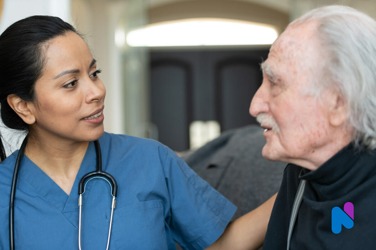 female nurse at home with senior man