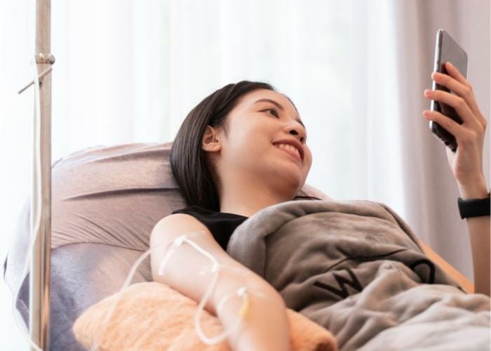 a woman receiving an iv infusion at home