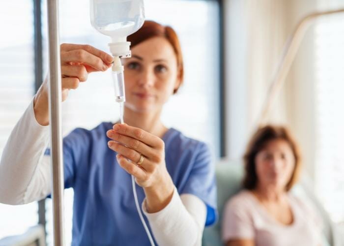 a private nurse administering an IV