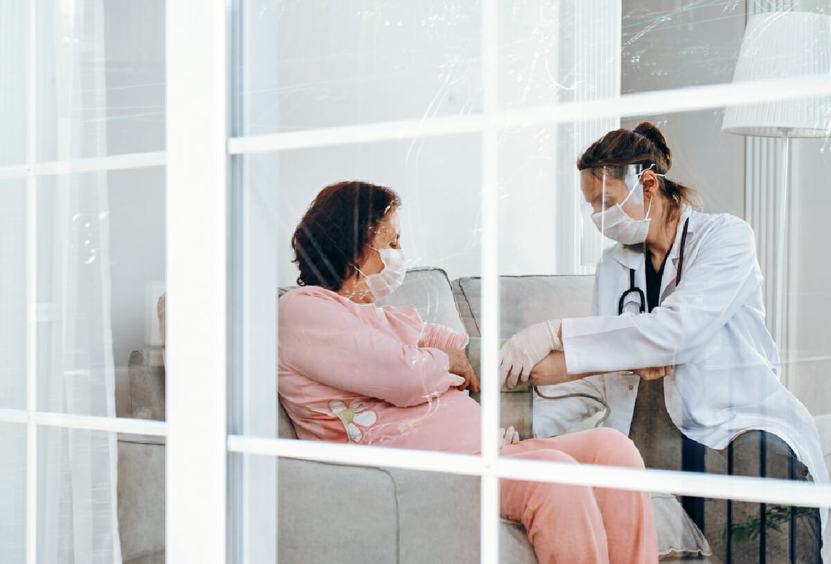 woman getting blood pressure read at home