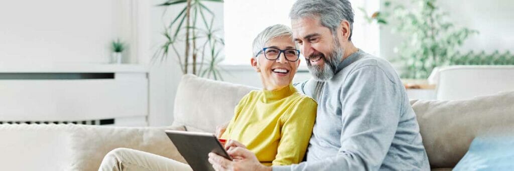 online orders older couple ordering sitting on sofa online