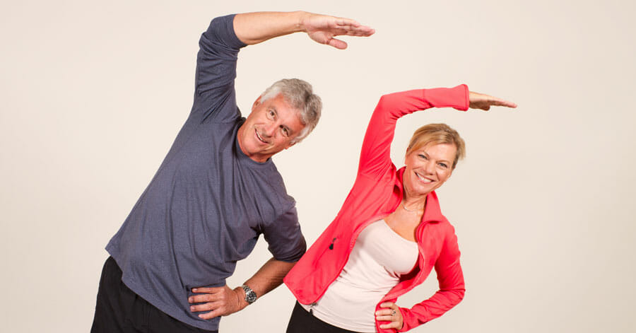 two mature adults doing Side Stretch 6