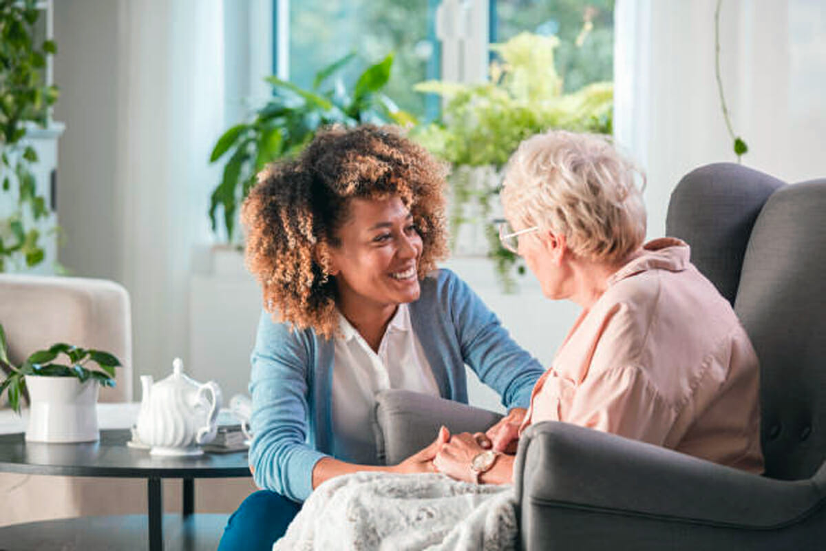 Nurse reassuring patient at home