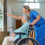 nurse pointing at where to look outside for patient