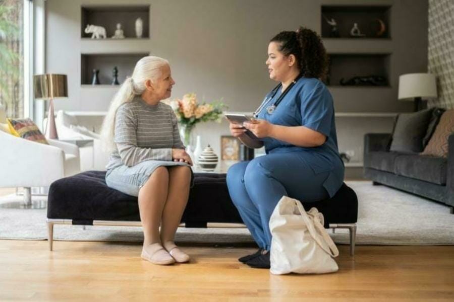 a nurse working with an elderly patient