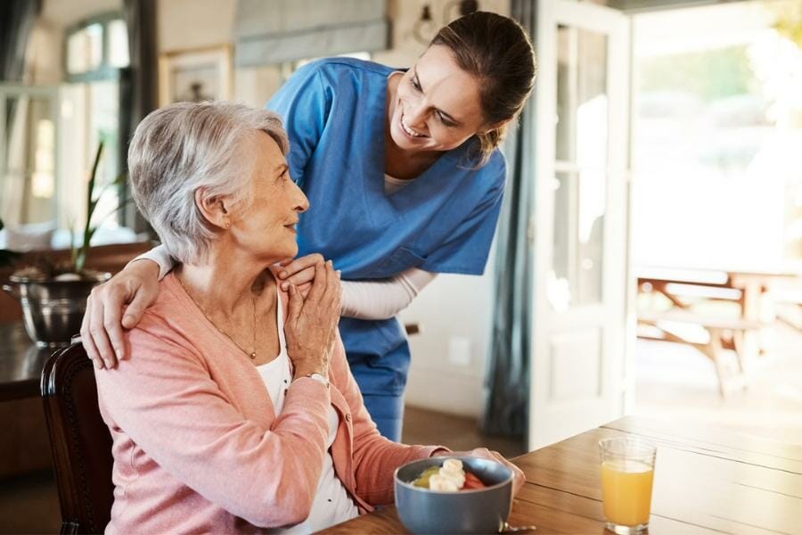 private nurse helping an elderly patient
