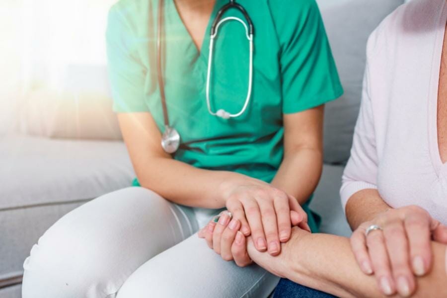 RN comforting their patient at home.