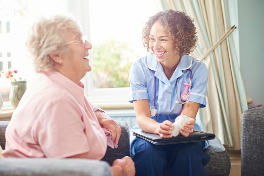 happy patient and nurse laughing