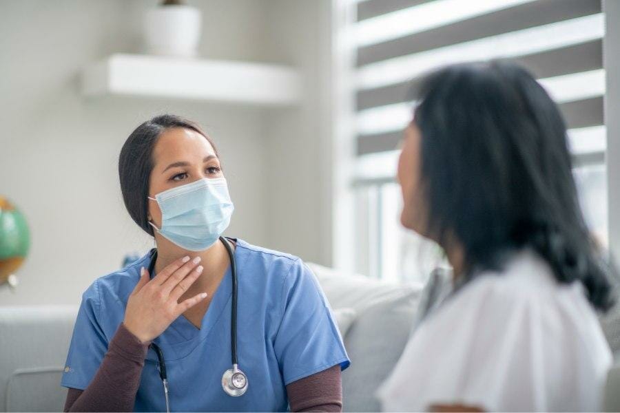 A private nurse offering a consultation to a potential client.