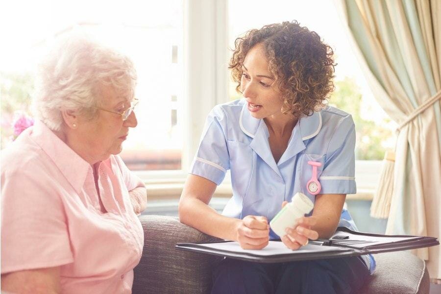 Private nurse assisting with medication management for a patient.