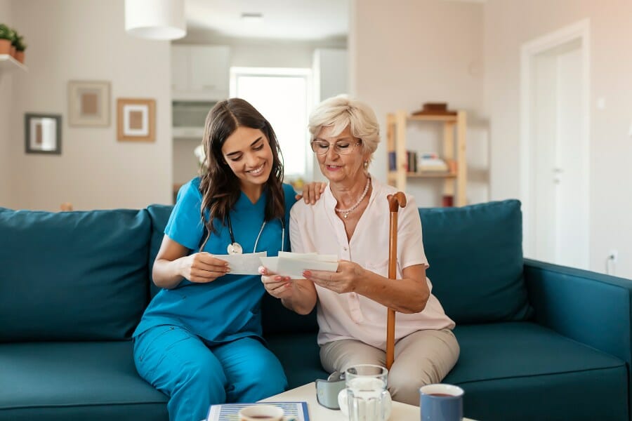 private nurse working with an elderly patient