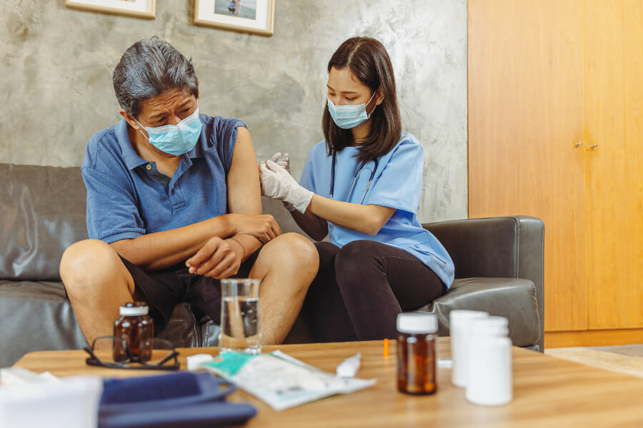 A psychiatric nurse giving medication via injection.