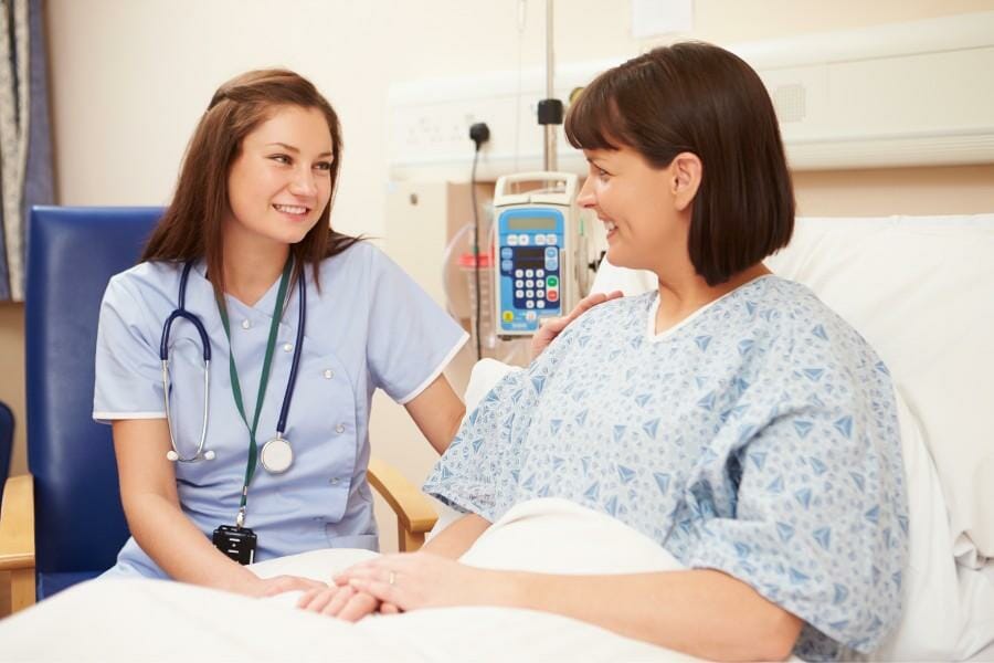 Los Angeles nurse consulting a patient.