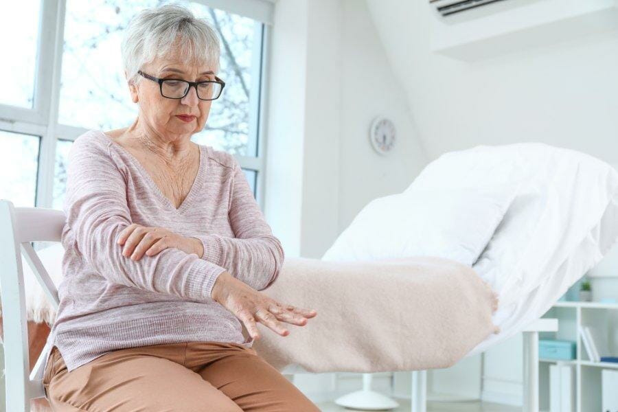 A woman suffering from tremors due to parkinson's disease